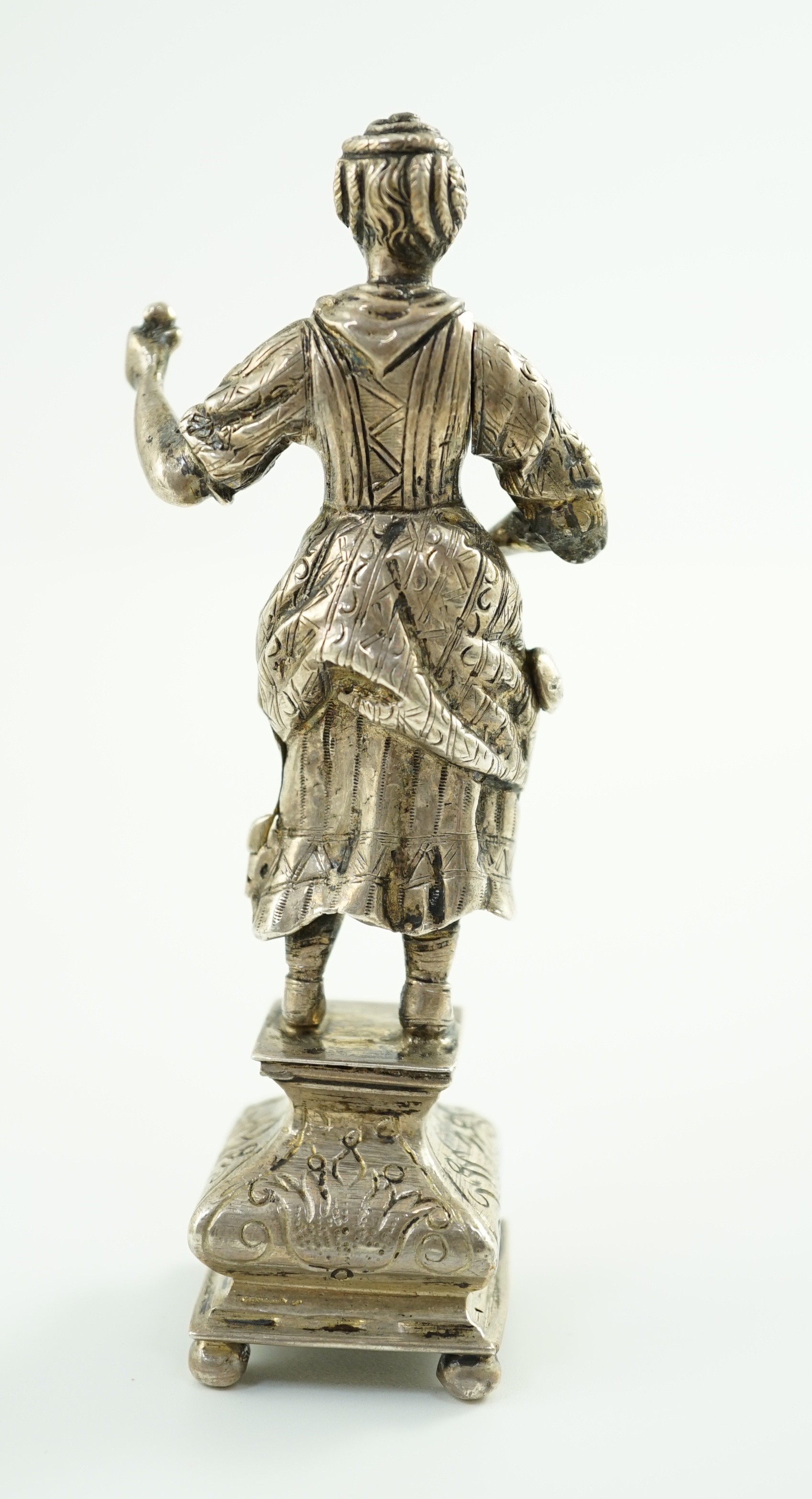 A late 19th century Dutch silver erotic miniature figure of a lady, on a square base with ball feet